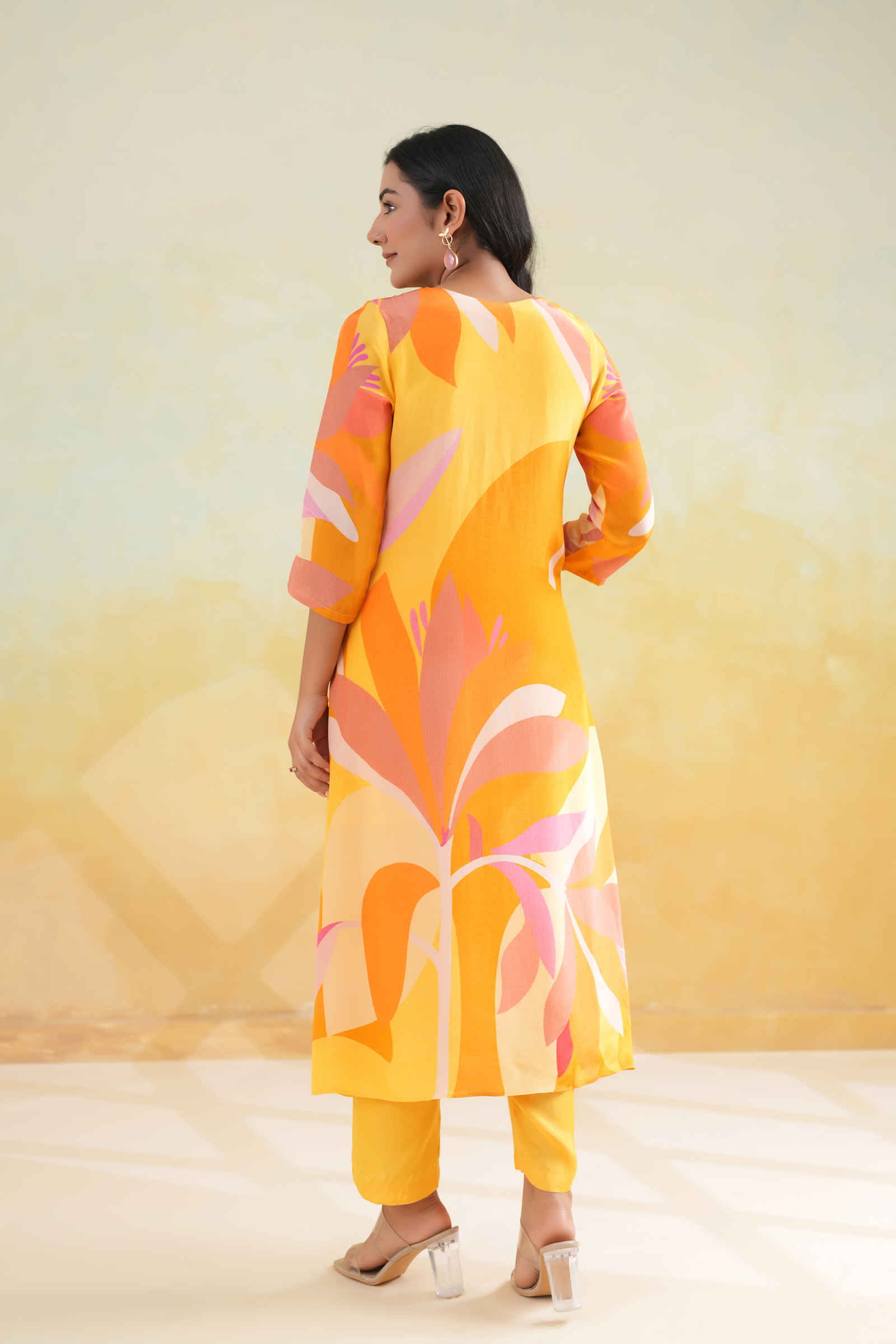 vibrant yellow and orange printed kurta with pink abstract floral patterns and delicate sequin highlights — a perfect blend of comfort and statement style for summer days and festive occasions.